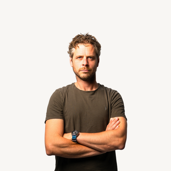 Andrew Felton, co-founder of OOST Nutrition, standing arms crossed against a plain background