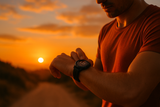 Image of a male runner at sunset checking his sports watch