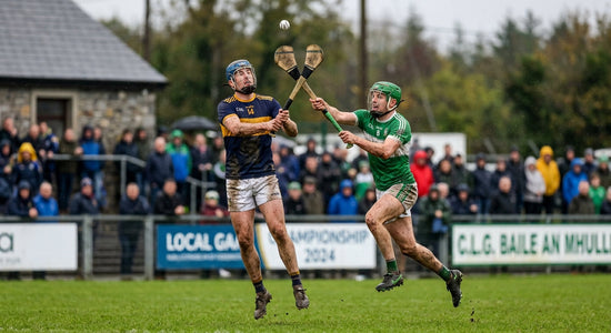 GAA hurling players contesting a high ball during a club championship match