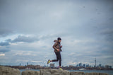 Man running on cloudy day